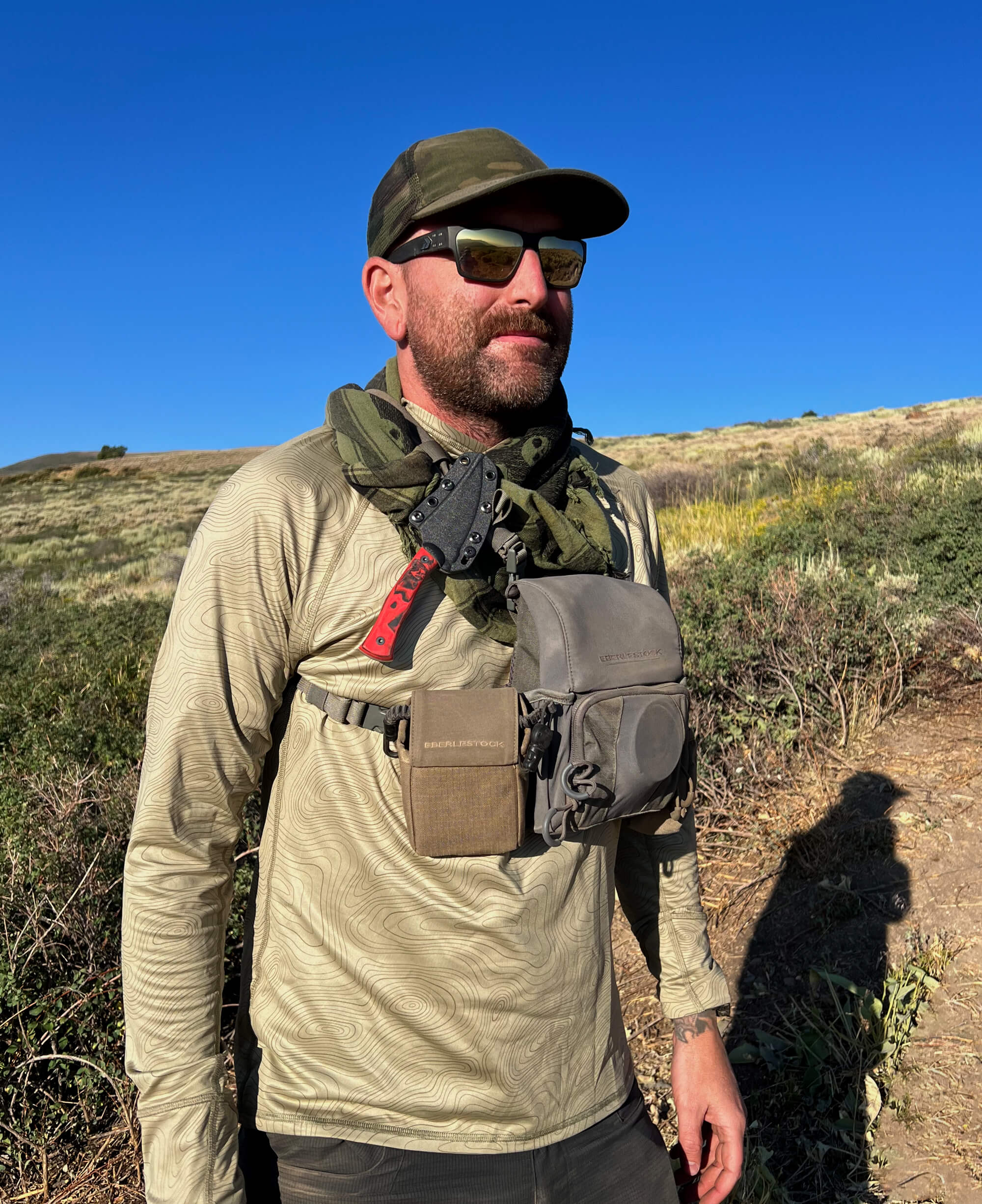 Man in an outdoor setting with a hunting knife.