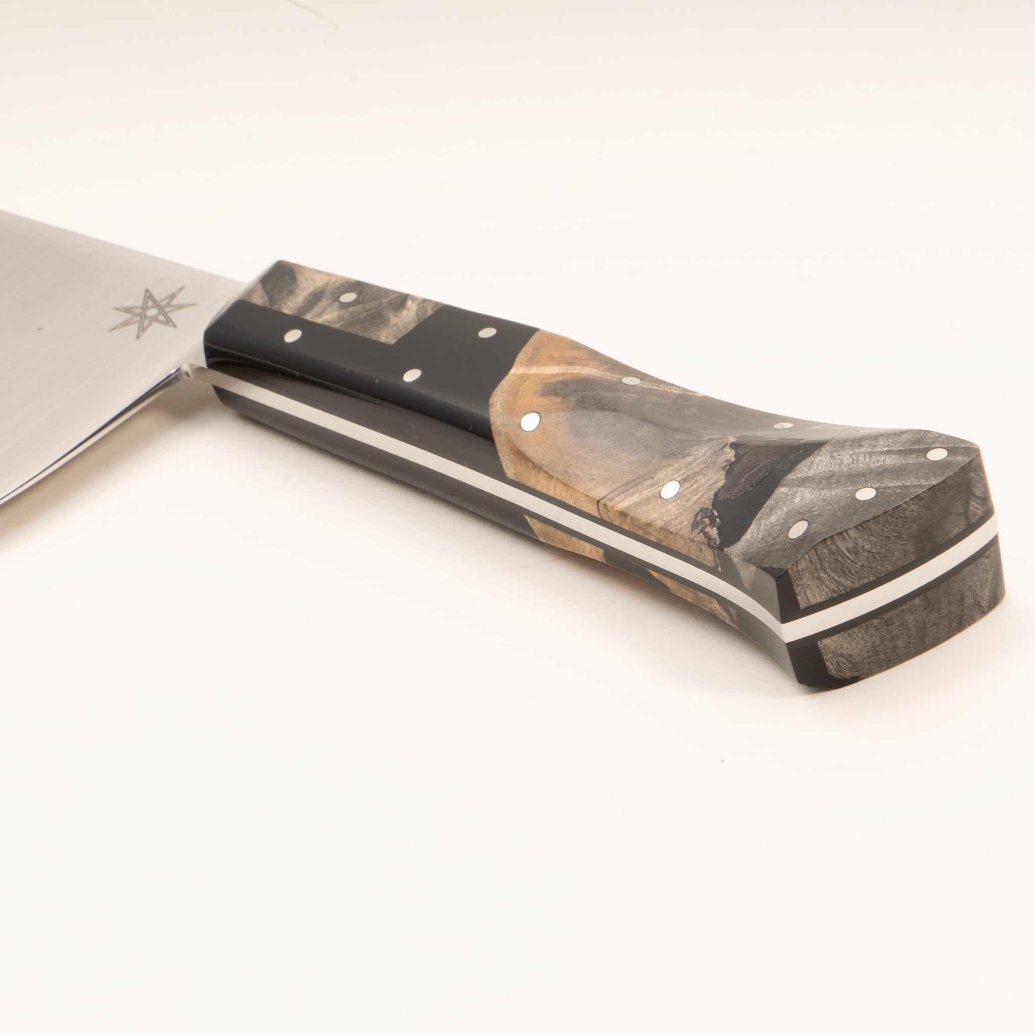 Close-up of a kitchen chopper knife handle made from wood and black resin, on a white background.