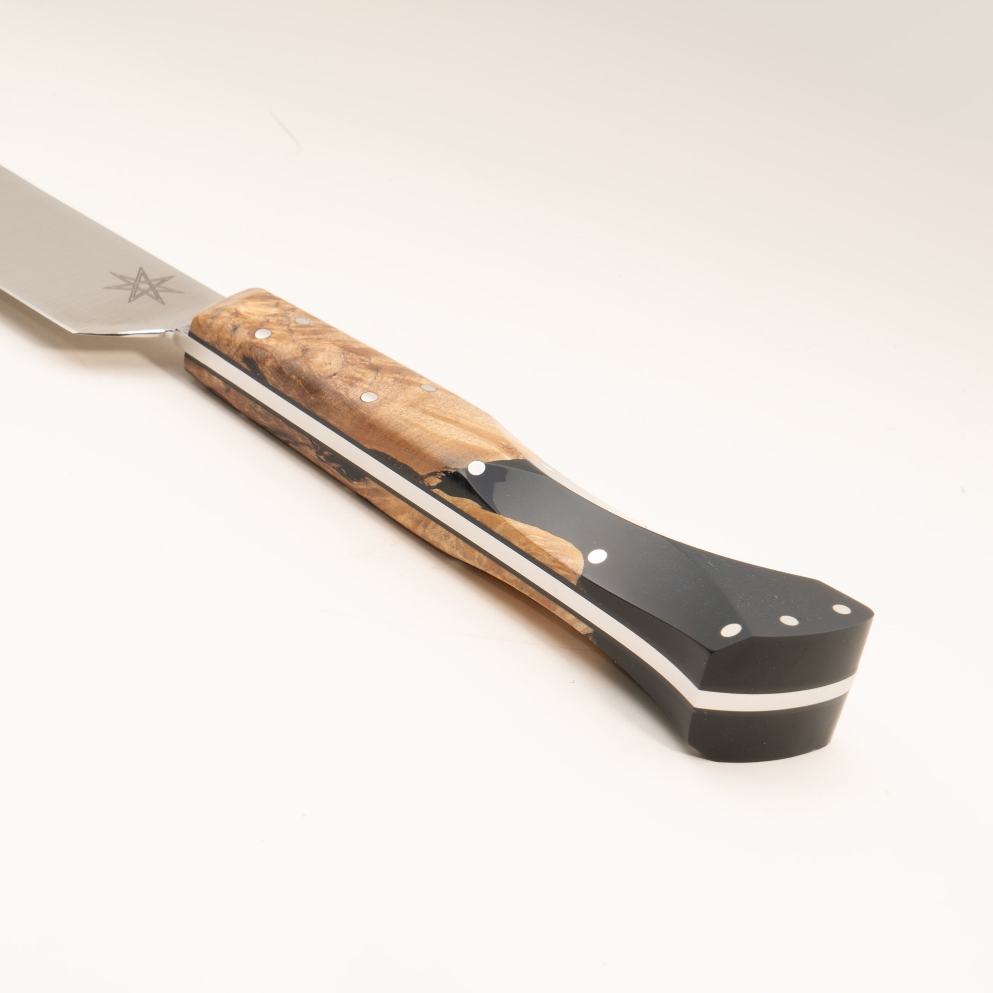 Close-up of a kitchen slicer carving knife handle made from wood and black resin, on a white background.