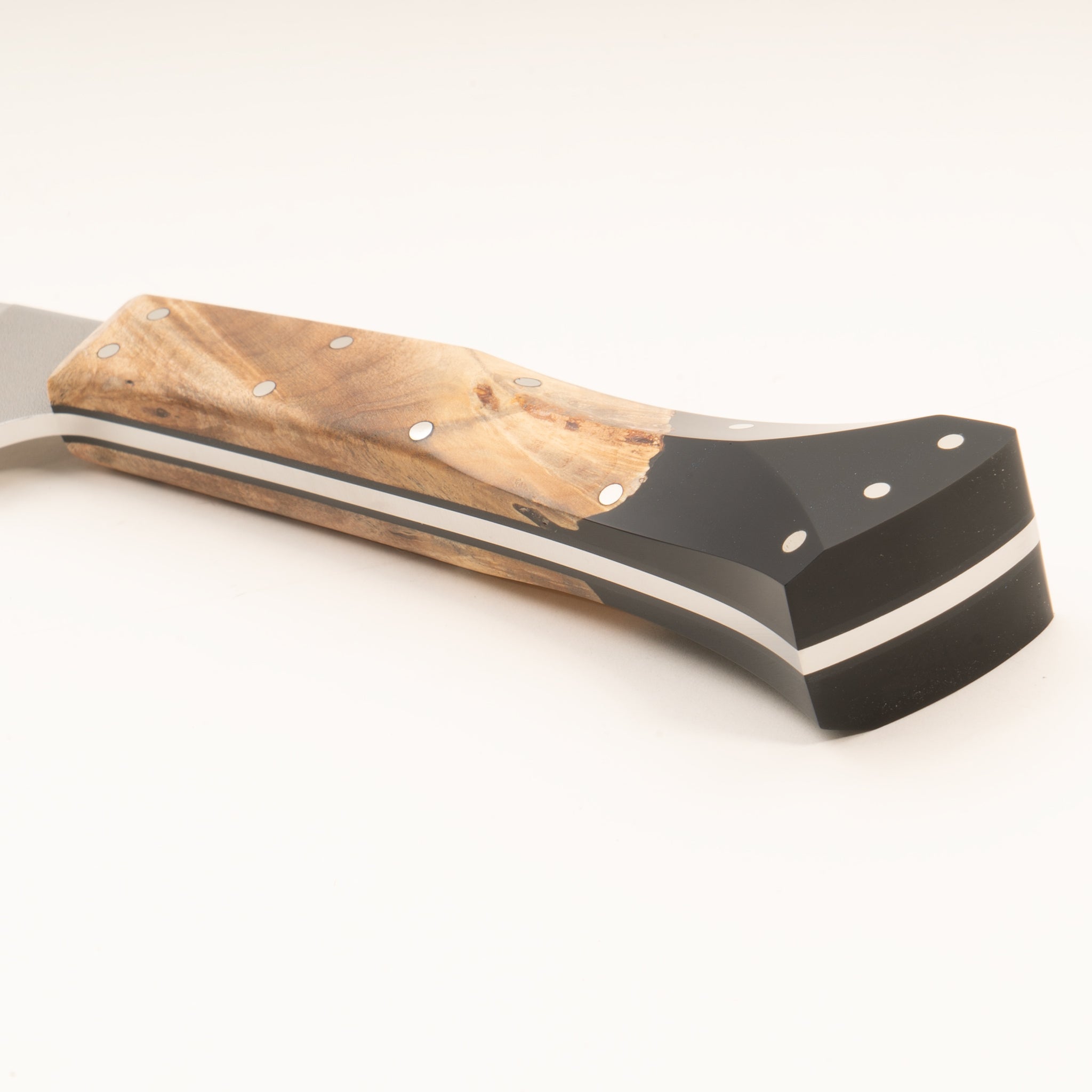 Close-up of a knife handle with wood and resin on a white background.