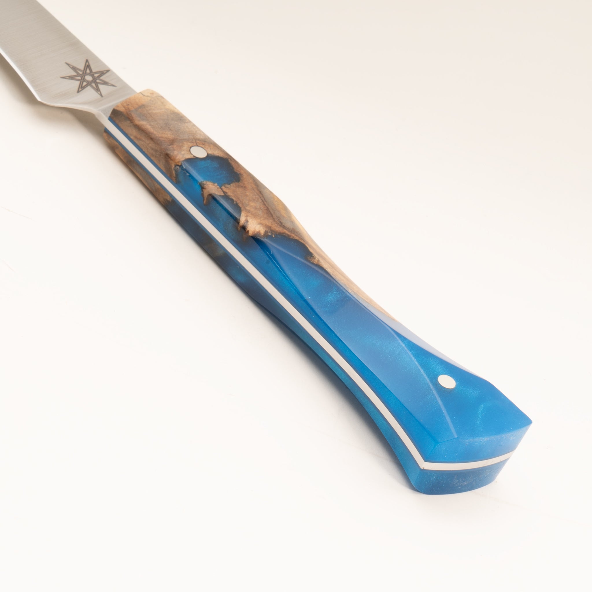 Detail photo of knife handle of Tahoe Bliss stainless steel bird's beak knife with buckeye burl wood and blue resin handle by Town Cutler.