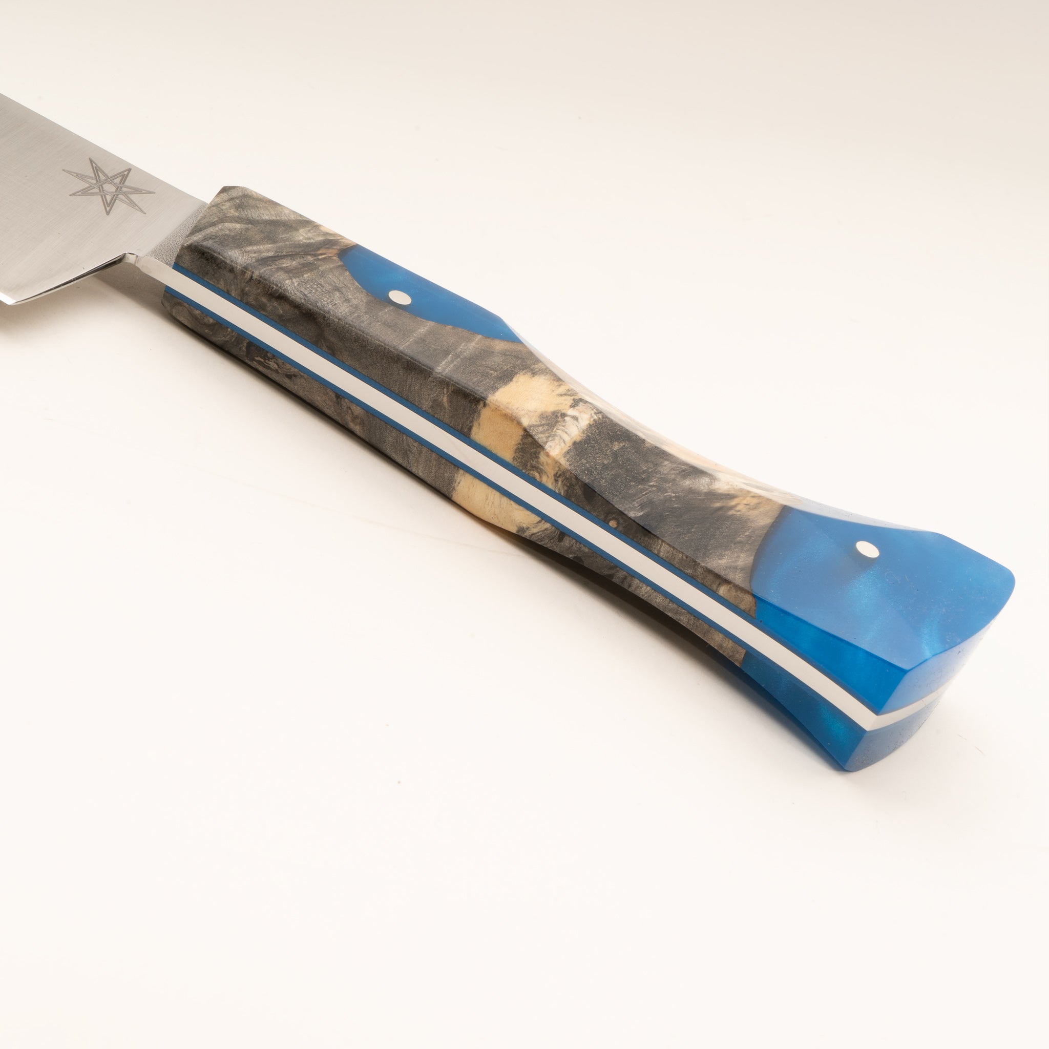 Detail photo of knife handle of Tahoe Bliss stainless steel scimitar butcher knife with buckeye burl wood and blue resin handle by Town Cutler.
