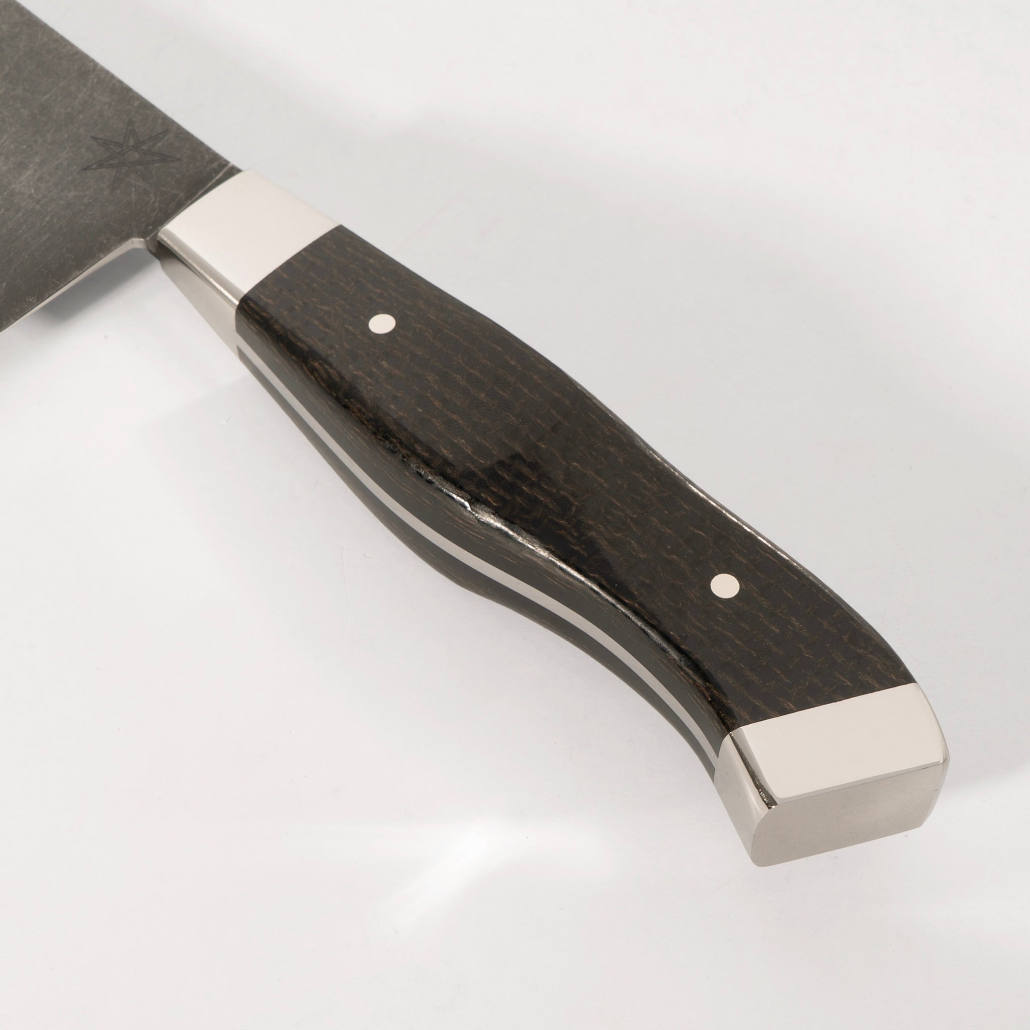 Detail photo of handle on 10" Carbon Steel Chef Knife with Stonewash Finish Blade, Black Burlap Micarta Handle, Stainless Steel Bolster and Pommel by Town Cutler