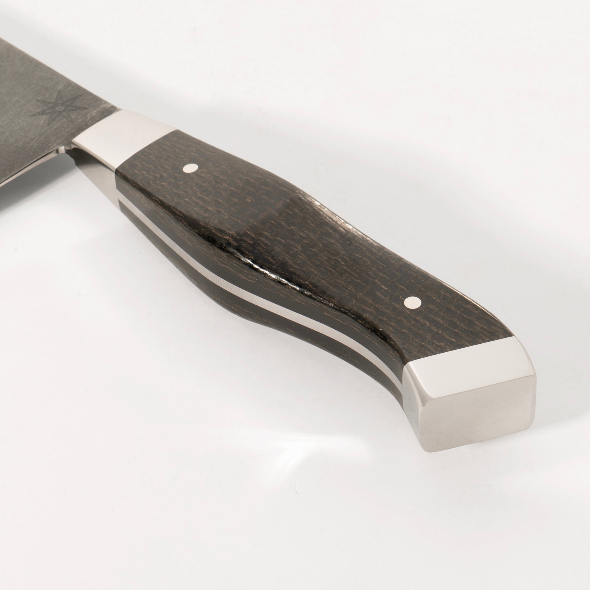 Detail photo of handle on 8.5" Carbon Steel Chef Knife with Stonewash Finish Blade, Black Burlap Micarta Handle, Stainless Steel Bolster and Pommel by Town Cutler