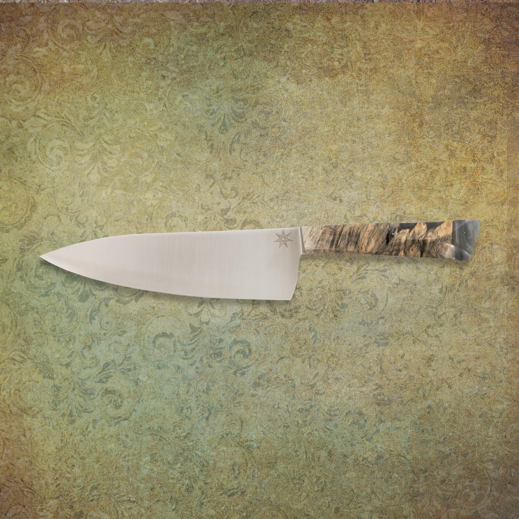 7" stainless steel chef knife with silvery resin and buckeye burl wood handle.
