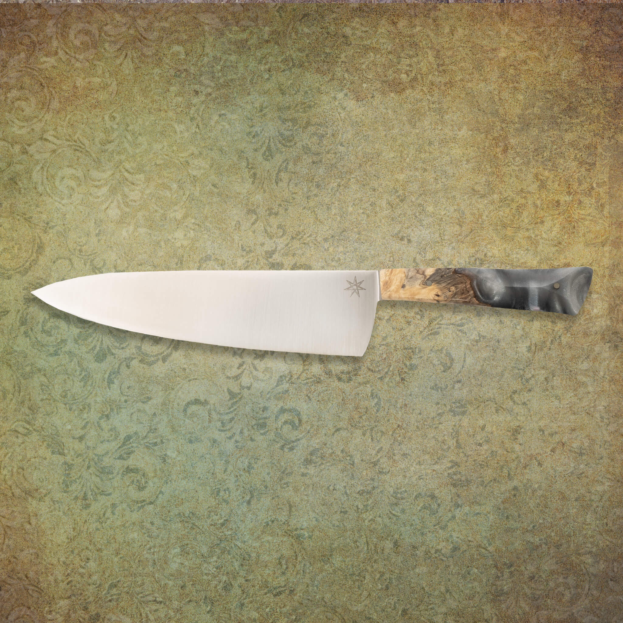 8.5" stainless steel chef knife with silvery resin and buckeye burl wood handle.