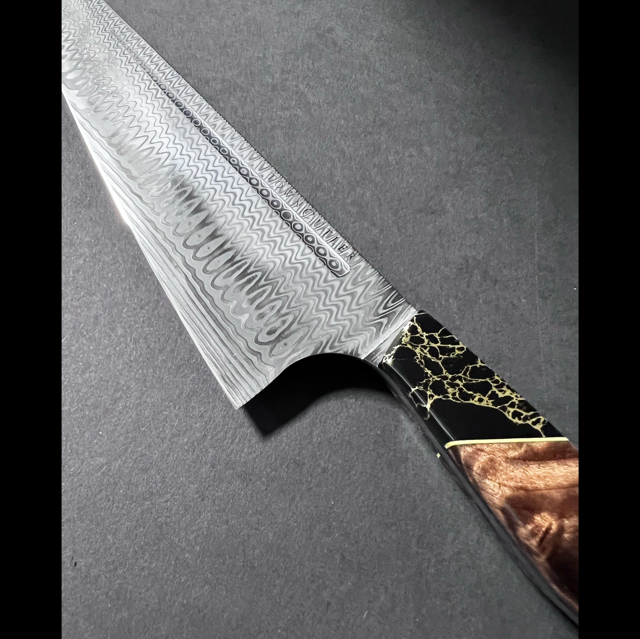 Town Cutler Damasteel Chef Knife. Knife blade is made from Damasteel® Björkmans Twist™ Damascus Steel. Handle is made from Ironwood with Buckeye Burl Moons and Black G-10 Liner