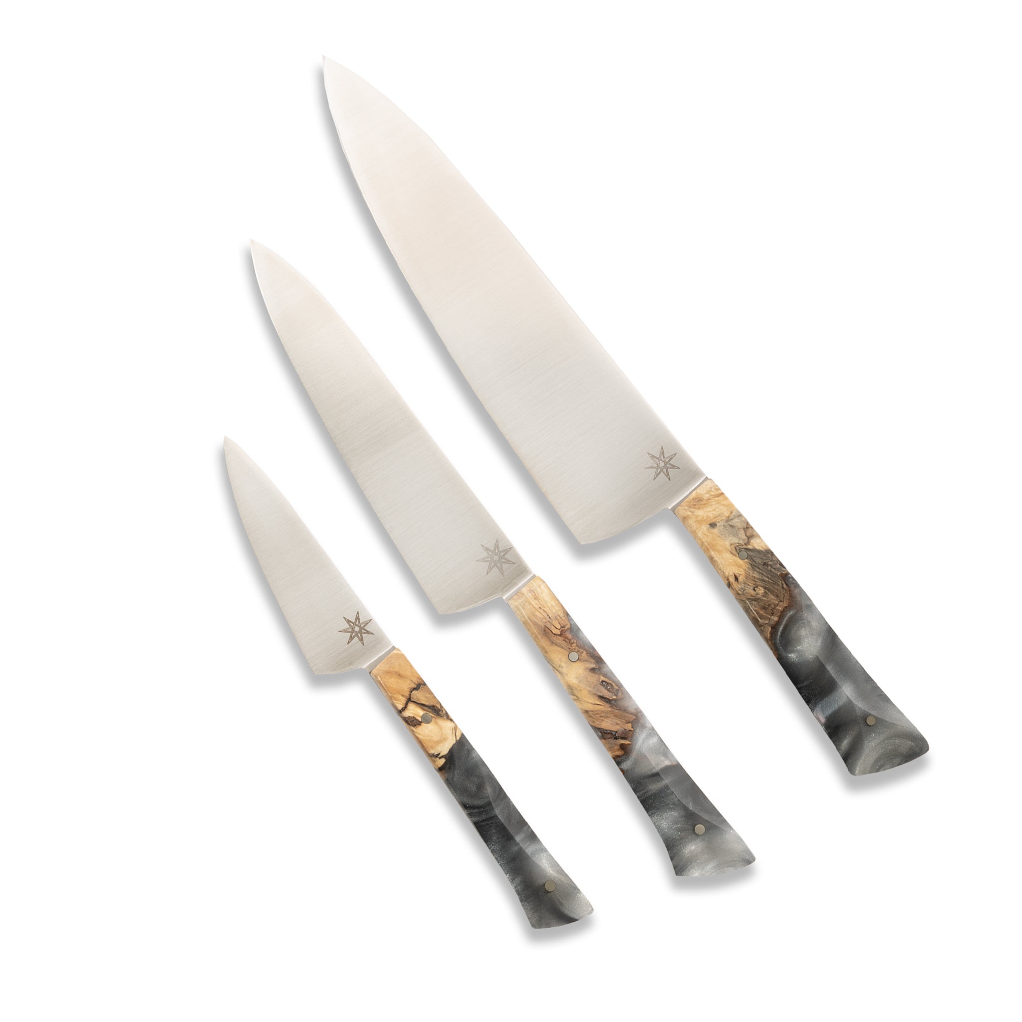 Three-piece handcrafted kitchen knife set with gray silver resin handles and wood.