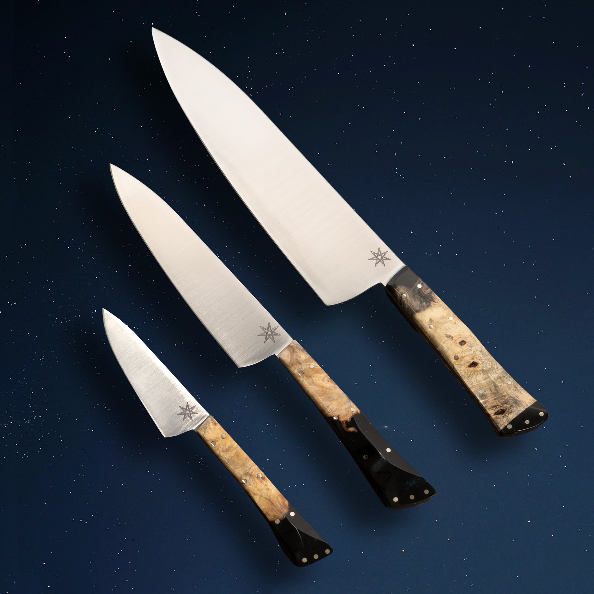 Desert Dawn Sous Chef Set from Town Cutler. Kitchen knife set with three knives. 8.5" Chef Knife, 6" Utility Knife, and 3" Paring knife with buckeye burl and black resin handles.