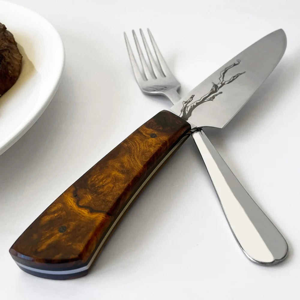 Town Cutler Olneya Steak Knife on white tablecloth with fork.