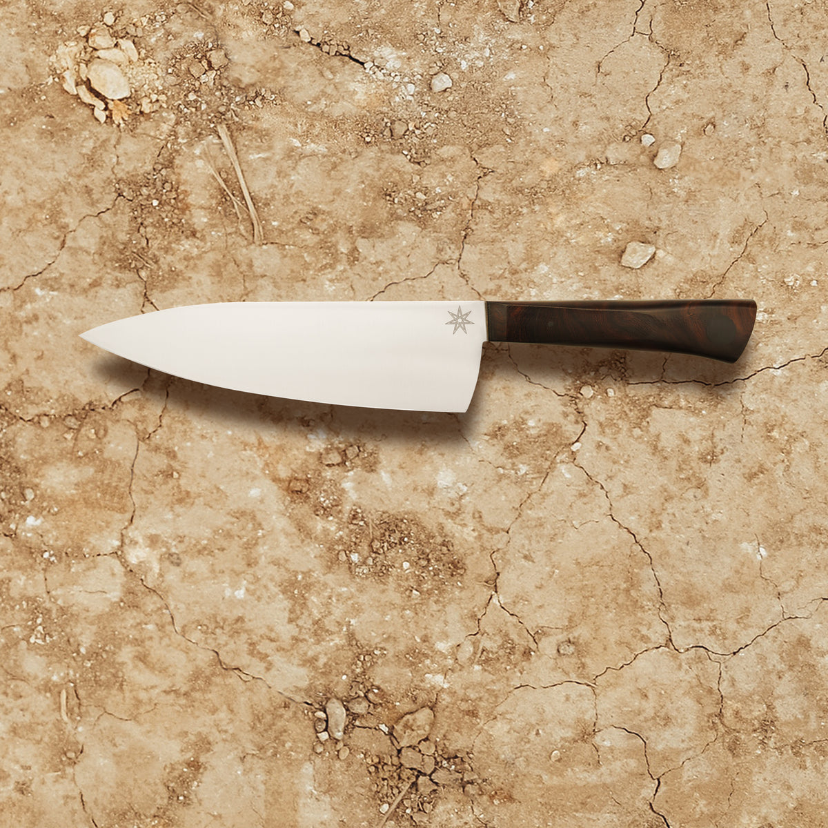 7" chef knife for those who prefer a slightly smaller chef knife. Made with stainless steel and desert ironwood. Kitchen knife with wood handle and branch design and star engraved on blade.